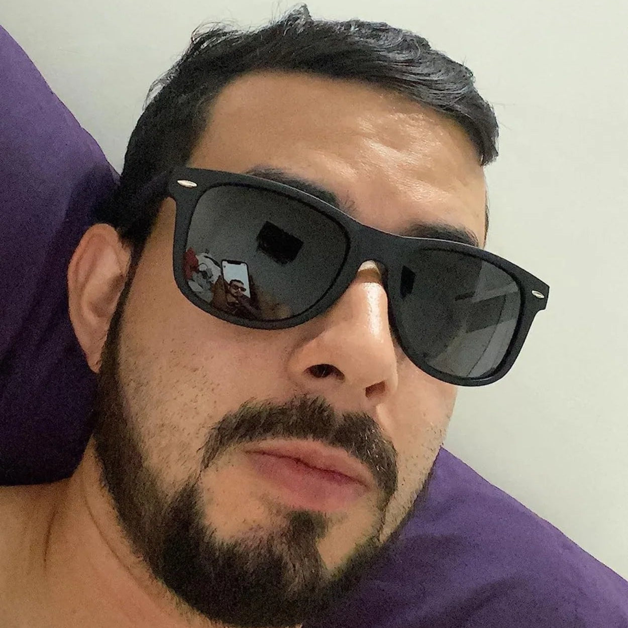 Man wearing sunglasses with a blurred background